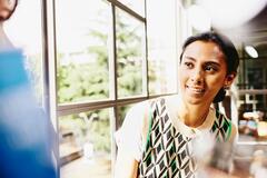 Smiling woman looking at someone.