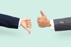 Dwie ręce z rękawami od garniturów, jedna pokazuje kciuk w górę, druga kciuk w dół