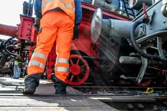 Railway worker in action at railway station.