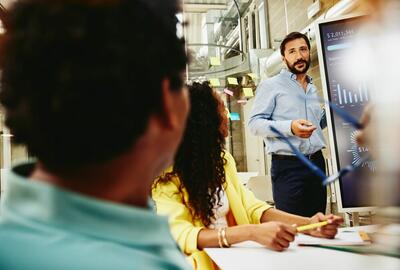 Three colleagues having a meeting in a meeting room.