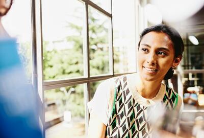 Smiling woman looking at someone.