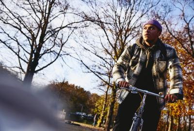 Cycling man, autumn trees on the background.