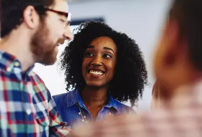 Group of colleagues talking and laughing. 
