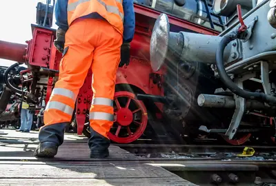 Railway worker in action at railway station.