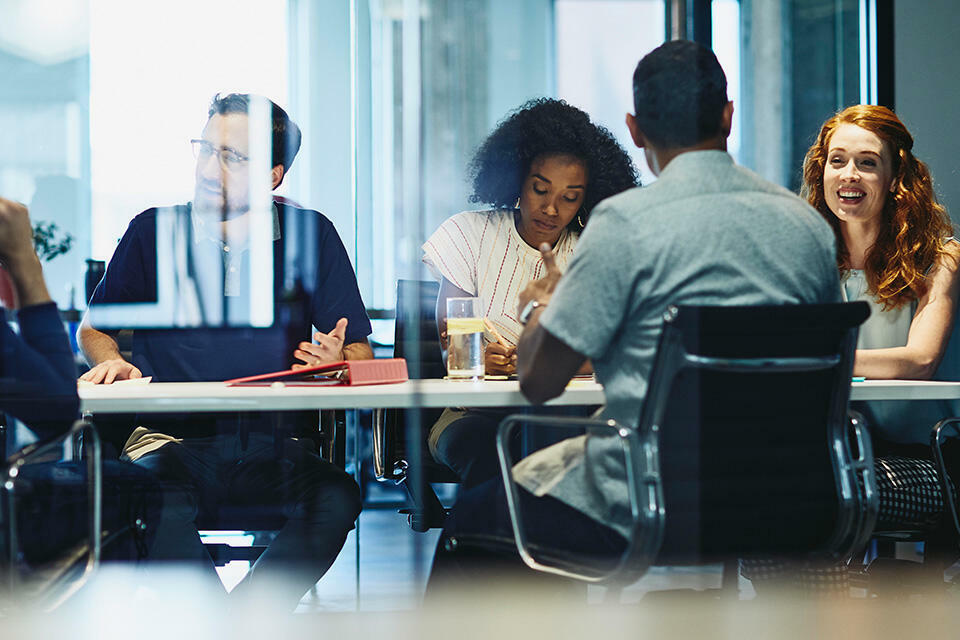 Group of colleagues sitting in a meeting room.