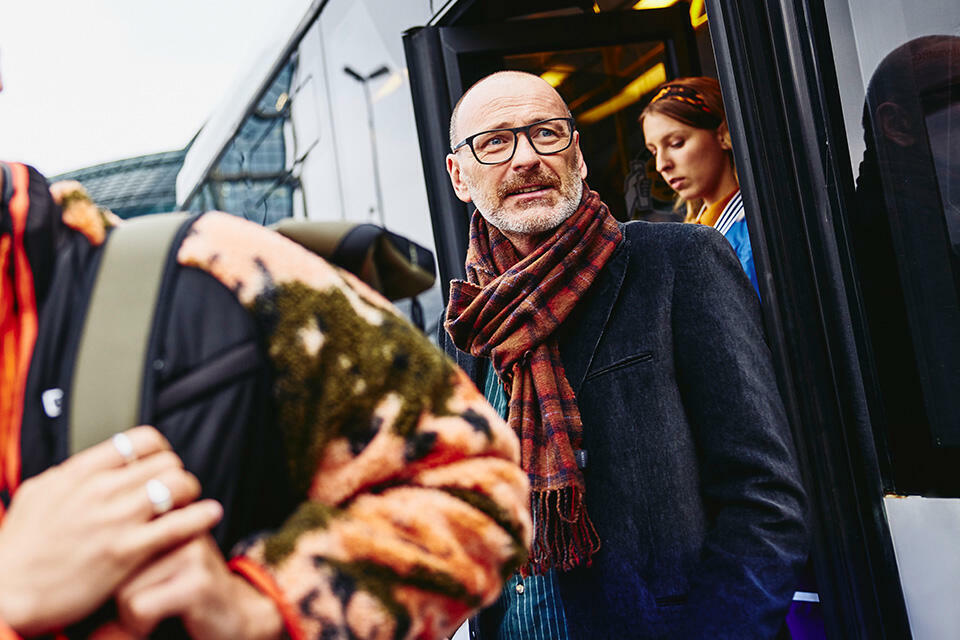 People getting out of a bus.